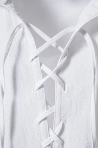 Detailed view of cross-laced neckline on white cotton linen short-sleeve shirt