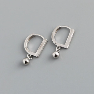Detail of silver D-shape hoop earrings with crystal pavé and smooth bead drop charms
