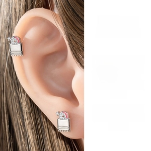 Detail view of pink enamel screw cartilage stud with micro zircon on a human ear