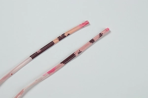 Close-up of pink floral print dress straps with fine stitching and silky texture