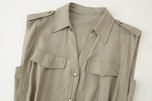 Detail view of khaki linen sleeveless dress featuring shoulder tabs and front flap pockets
