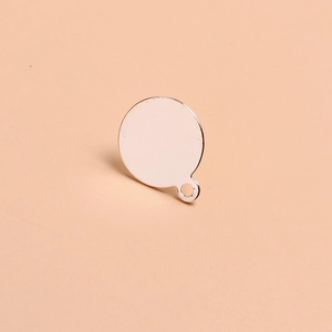 Macro detail of round silver metal charms for DIY jewelry making with smooth finish