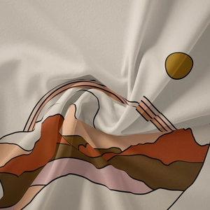 Detail of bohemian tapestry fabric showing abstract mountain print and sun pattern