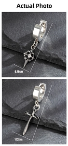 Detailed view of punk cross earrings with white rhinestones and black stone sword pendants