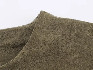Nahaufnahme von olivgrünem Wildlederimitat mit weicher Textur und mattem Finish