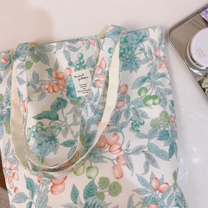 Detail of floral canvas tote bag showing neat stitching and stylish woven label
