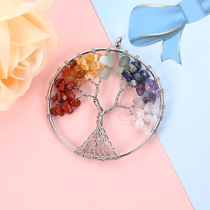 Close-up of tree of life pendant with silver wire wrap and colorful chakra stones