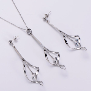 Silver twisted drop earrings and necklace set with sparkling crystals on white background