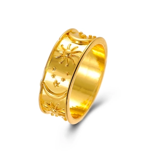 Macro view of gold vintage ring featuring celestial sun, moon, and star relief details