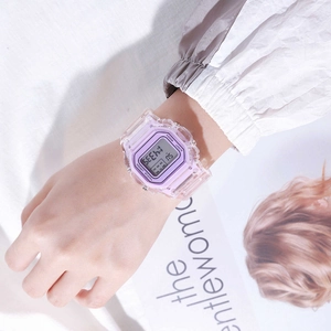 Detail view of transparent purple digital watch with square face on a female wrist