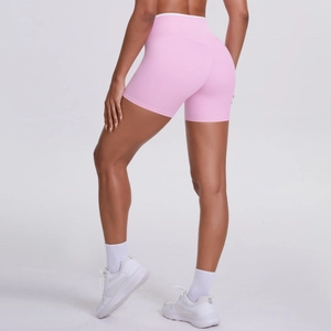 Rear view of pink high-waist yoga shorts showing peach lift effect and seamless fit