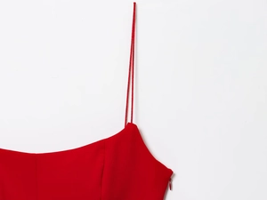 Close-up of red camisole top featuring thin straps and a matching hidden side zipper
