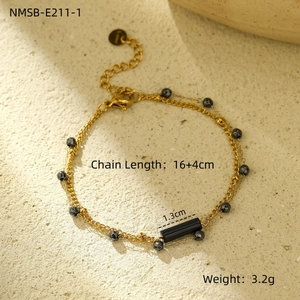 Detail showing 18K gold stainless steel chain with black beads and a heart pendant