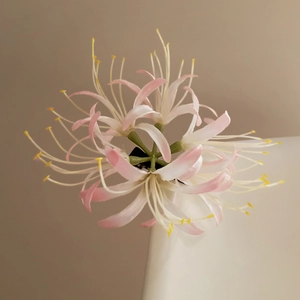 Detailed macro view of gradient pink lycoris hair clip with delicate silk flower petals