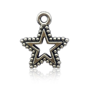 Macro shot of silver star pendant charm with circular loop for DIY jewelry making