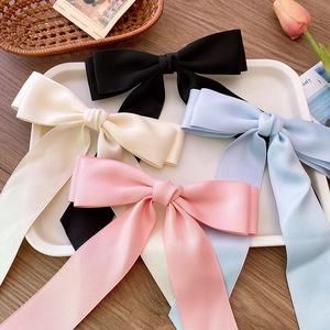 Detailed set of satin ribbon bow hair clips in black, beige, pink, and light blue colors