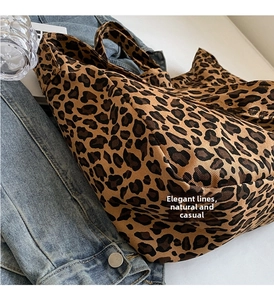 Detail of leopard print canvas tote bag showing twill fabric texture and durable handle