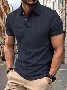 Detail of navy knit polo shirt featuring herringbone texture and gold buttons