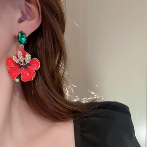 Elegant floral stud earrings with red petals, emerald gem top, and micro-inlaid diamonds