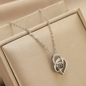 Close-up of heart pendant engraved with I love you to the moon and back text