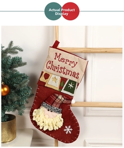 Detail of red felt Christmas stocking with Merry Christmas text and Santa Claus embroidery