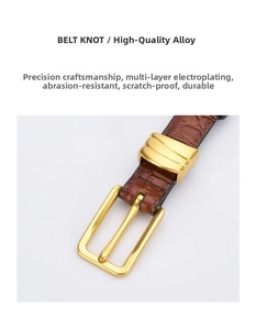 Detail of golden pin buckle on brown crocodile pattern leather belt with polished finish