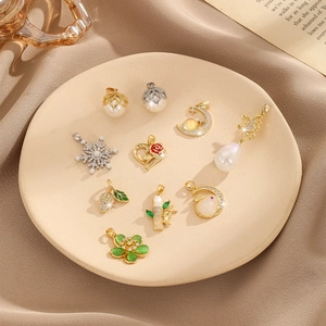 Collection of Neo-Chinese style pendants with pearls, stars, and floral designs on a tray