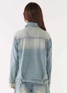 Detail of light blue washed denim jacket back seam and adjustable waist tabs