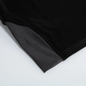 Detailed close-up of premium black velvet dress with mesh texture stitching detail