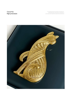 Detail of vintage gold leopard brooch featuring intricate carved textures and artistic design