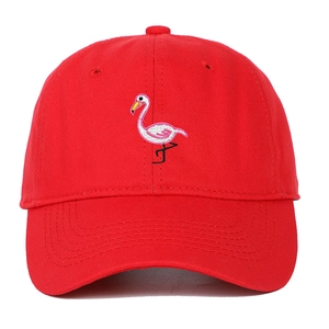 Detailed close-up of flamingo embroidery on a red soft top cotton baseball cap