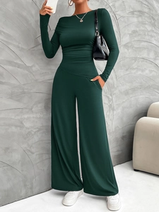 Detailed view of women's deep green Y2K long sleeve top and wide leg pants set