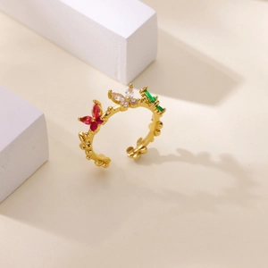 Close-up of golden adjustable ring featuring colorful butterfly-shaped zircons