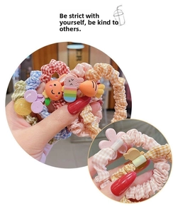 Detailed view of hair scrunchies with cute rabbit, carrot, and cherry charms