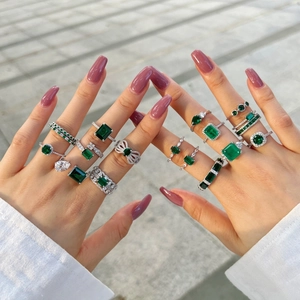 Detailed view of luxury S925 sterling silver rings with emerald and zircon stones