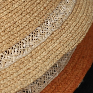 Detailed macro view of raffia sun hat showing intricate weave patterns and hollow textures