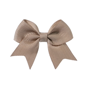 Detail of champagne gold grosgrain ribbon bow hair clip with textured ribbed fabric