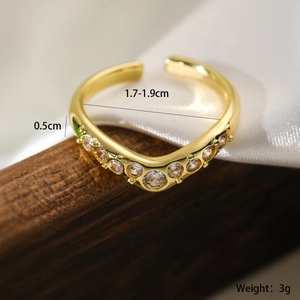 Detailed view of adjustable 18K gold plated ring with wave design and zirconia stones