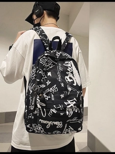 Street style black backpack with white graffiti pattern and XBOOM keychain accessory