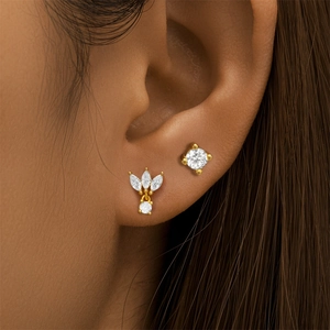 Macro shot of gold S925 sterling silver crown stud earrings with marquise cut diamonds