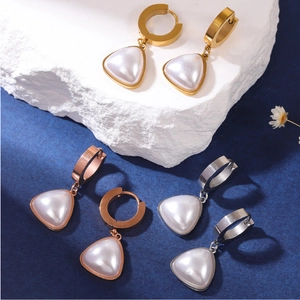 Detailed view of triangular pearl drop earrings in gold, silver and rose gold finishes