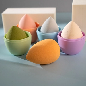 Five sets of colorful makeup sponges with portable cases in orange, green, and pink colors