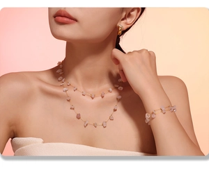 Detail of bohemian gold stainless steel jewelry set with pink natural stone on model