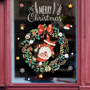 Christmas wreath and Santa Claus window decals with Merry Christmas text on glass
