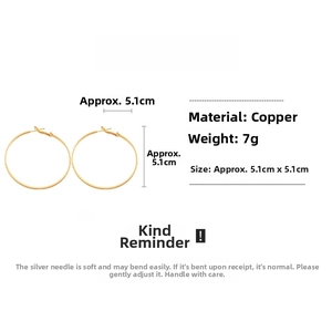 Detail of 5.1cm gold geometric hoop earrings made of copper with silver needles