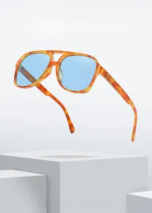 Detail of tortoise frame sunglasses with blue transparent lenses and double bridge design