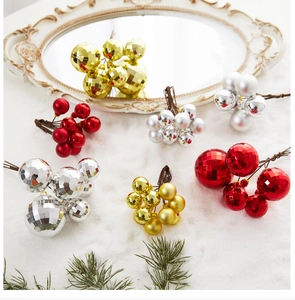 Detail of red, gold, and silver Christmas berry picks with matte and faceted finishes
