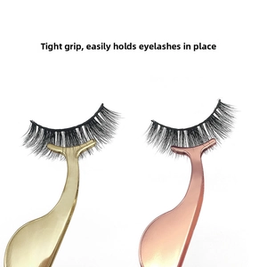 Close-up of crescent metal eyelash tweezers in gold and rose gold holding false lashes