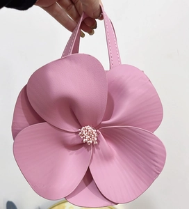 Detail of pink floral tote bag showing 3D petal design and faux pearl stamens