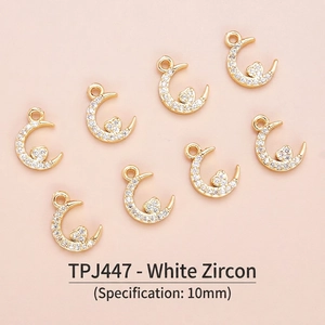 Detailed view of 10mm gold-plated moon and heart pendants with white zircon inlays